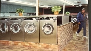 World O' Suds Coin Laundry, 430 E Main St Apopka FL — vintage interior shot showing the original founder-era washer row and brick counter