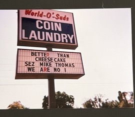 World O' Suds Coin Laundry, 430 E Main St Apopka FL — vintage photo of the road sign reading Better Than Cheesecake Sez Mike Thomas We Are No 1