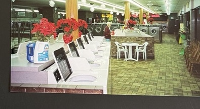 World O' Suds Coin Laundry, 430 E Main St Apopka FL — vintage photo of the laundry floor at Christmas with bicycles mounted above the washer and dryer row