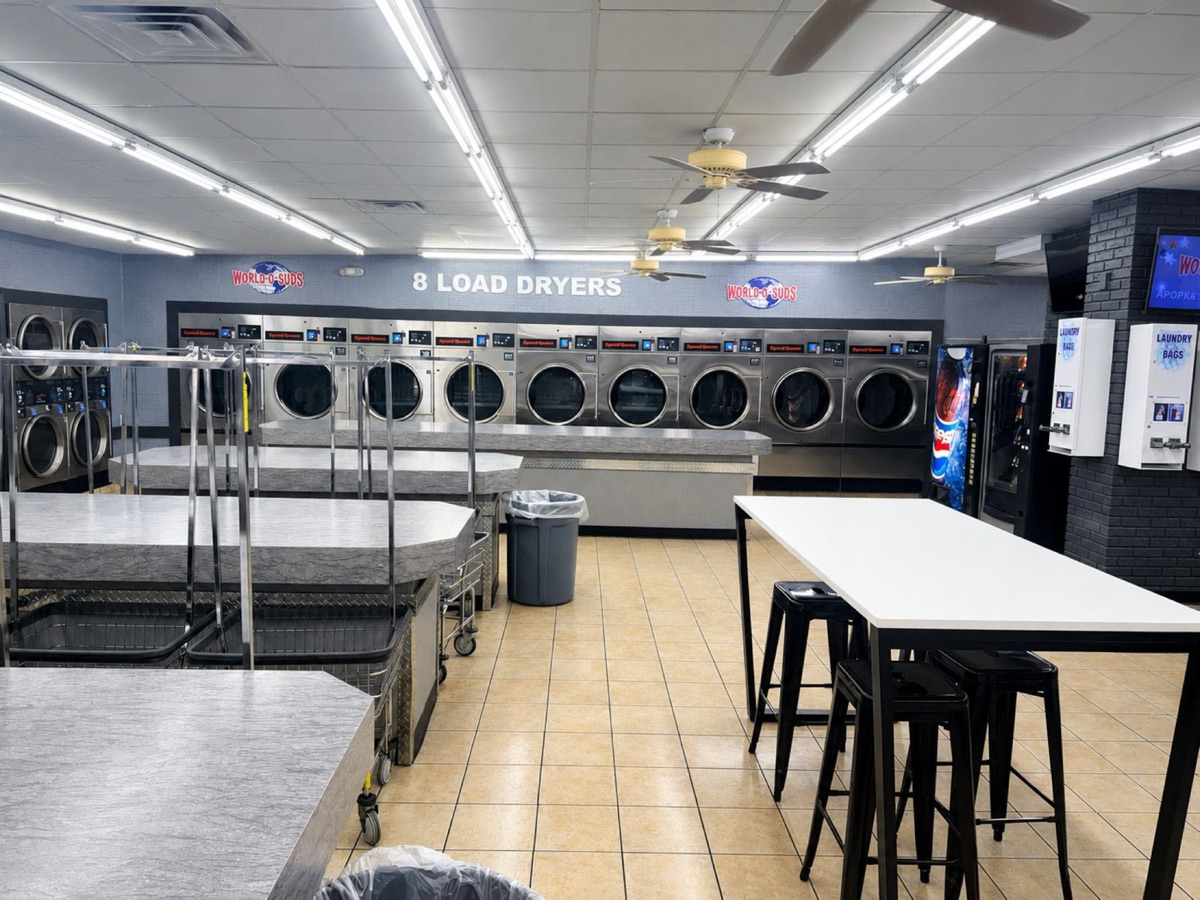 World O' Suds Coin Laundry, 430 E Main St Apopka FL — folding stations and tables on the main laundry floor