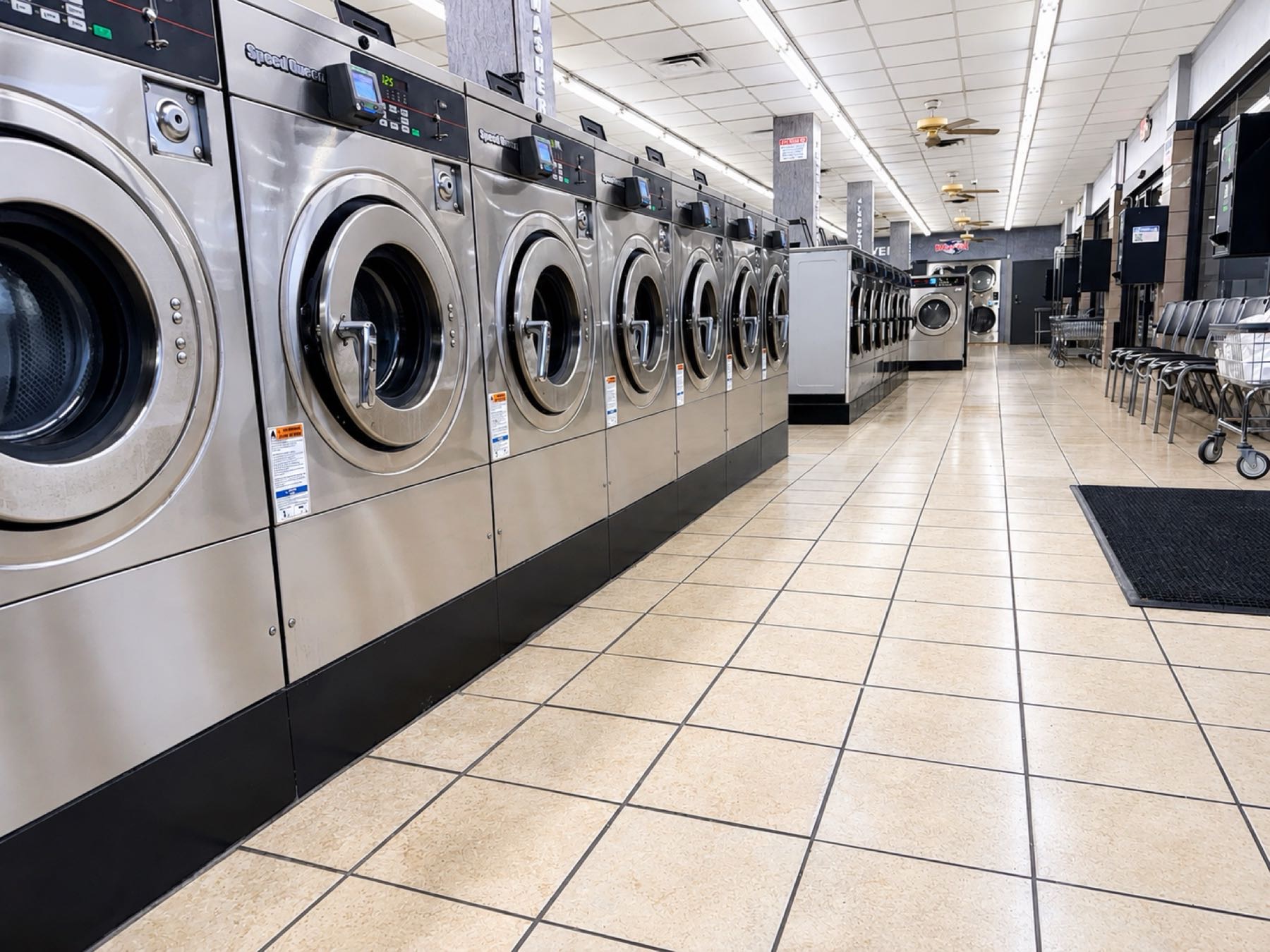 World O' Suds Coin Laundry, 430 E Main St Apopka FL — bright row of Speed Queen commercial washers on the main floor, 430 E Main St Apopka