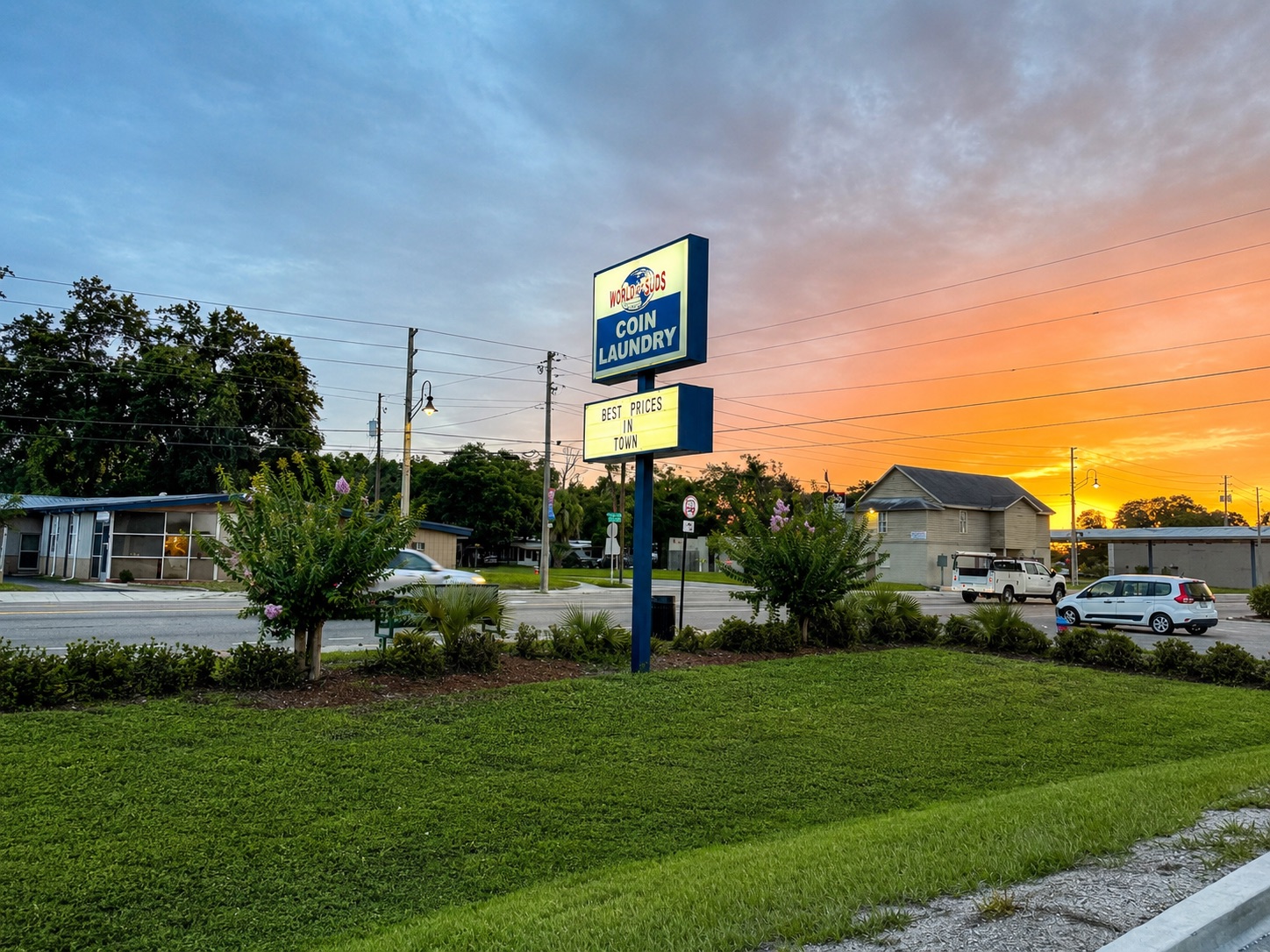 World O' Suds Coin Laundry, 430 E Main St Apopka FL — golden-hour road sign reading Best Prices in Town