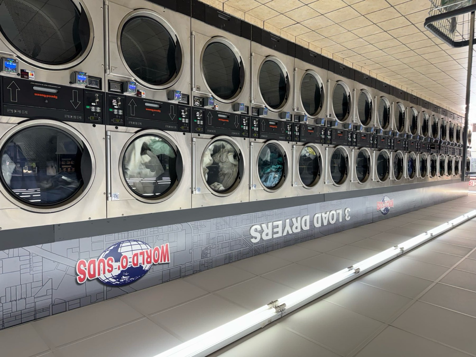 World O' Suds Coin Laundry, 430 E Main St Apopka FL — dramatic 3-load dryer wall with LED display panels