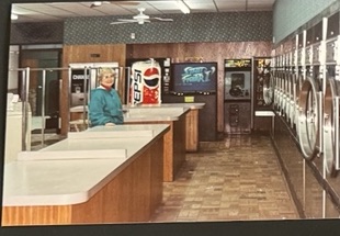 World O' Suds Coin Laundry, 430 E Main St Apopka FL — vintage photograph of the original laundry interior showing a man at the folding counter with a Pepsi vending machine and the washer row in the background