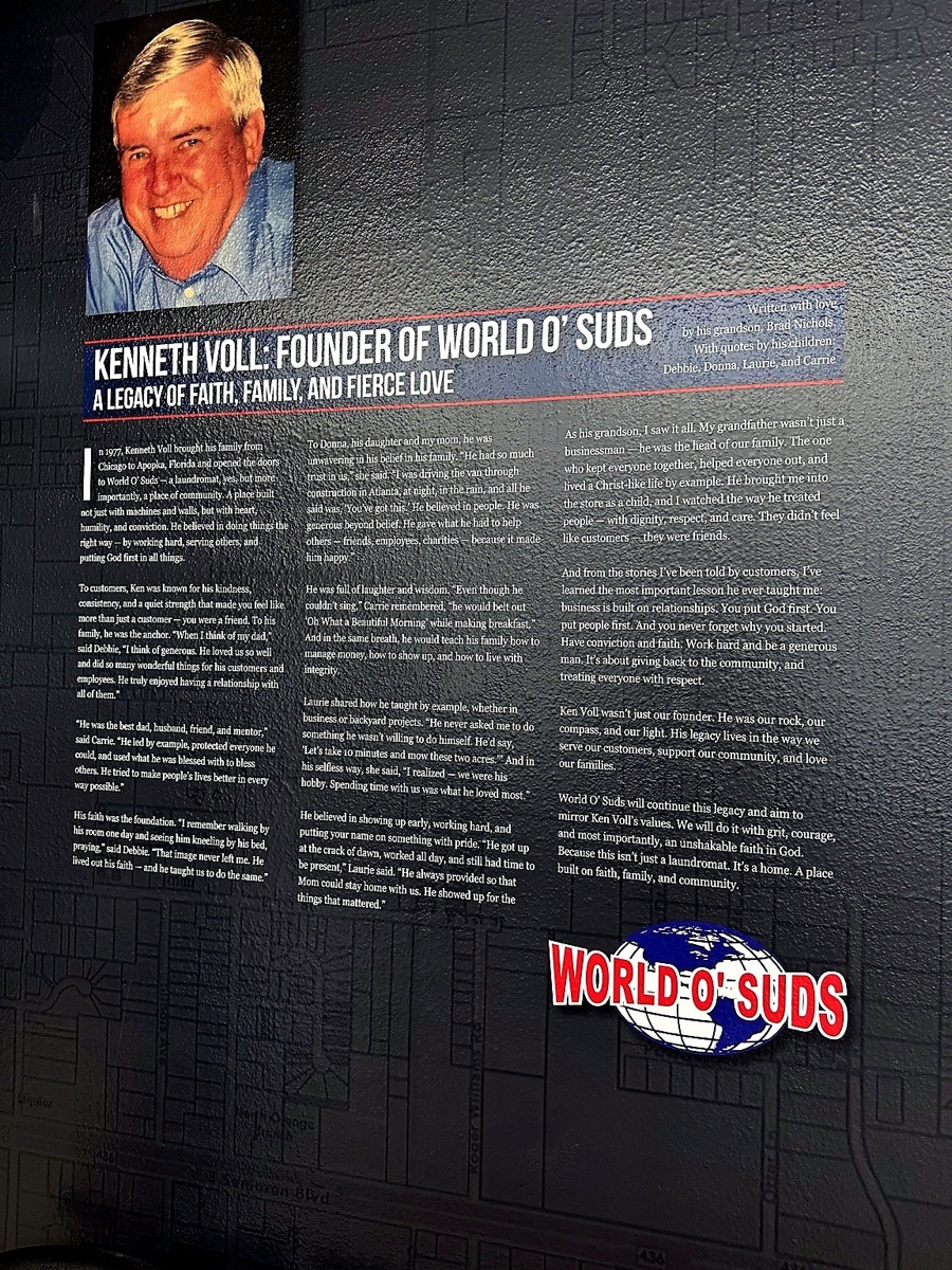 World O' Suds Coin Laundry, 430 E Main St Apopka FL — founder tribute wall honoring Kenneth Voll with memorial plaque and portrait photograph