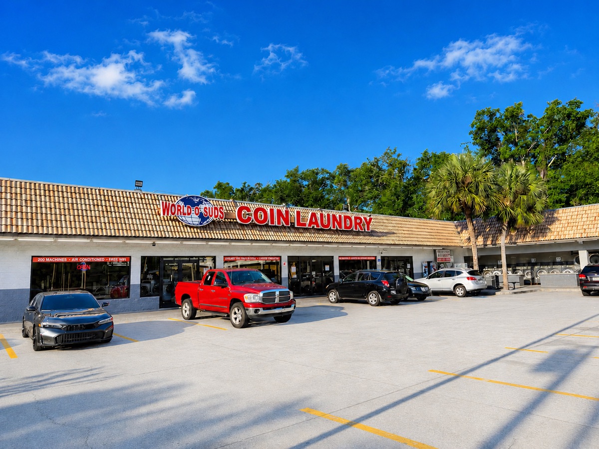 World O' Suds Coin Laundry, 430 E Main St Apopka FL — storefront exterior with bright blue sky and full parking lot